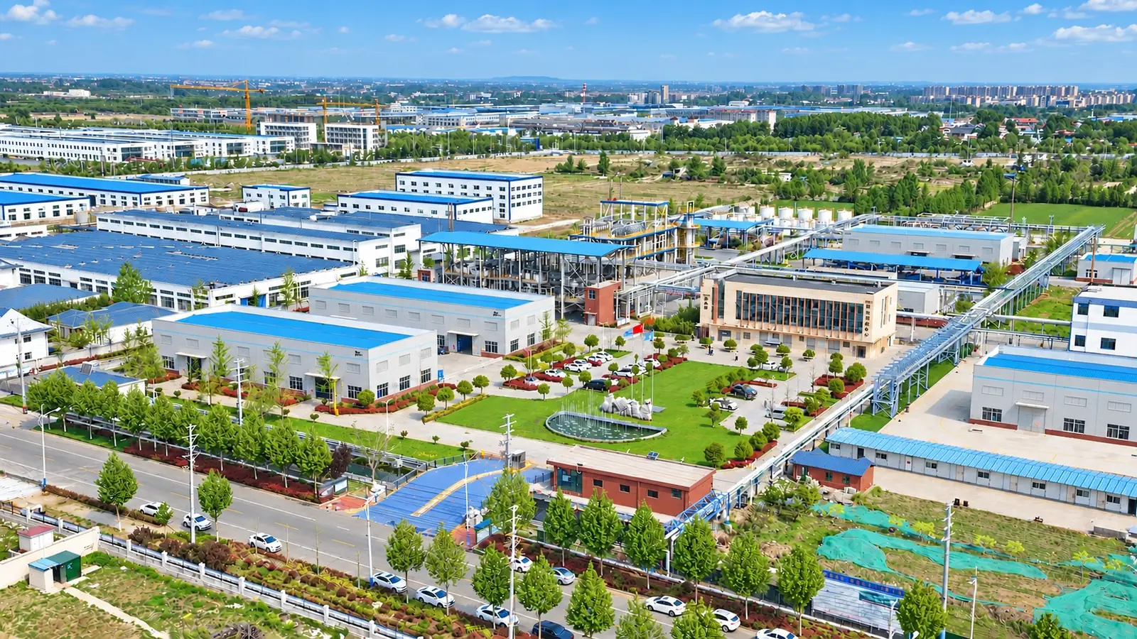 Aerial view of the DECHEM manufacturing base: production workshops, tank farm, utilities and landscaped grounds